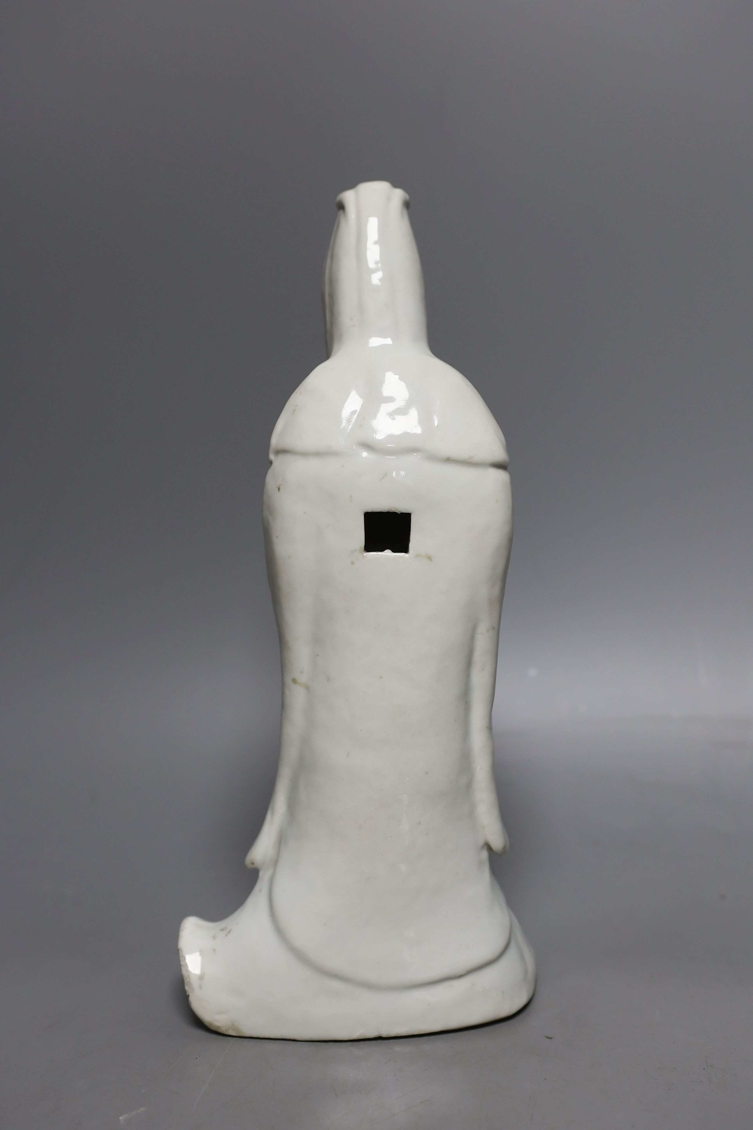 A Chinese blanc de chine figure of Guanyin, probably 18th century and two famille rose plates. Tallest 26cm